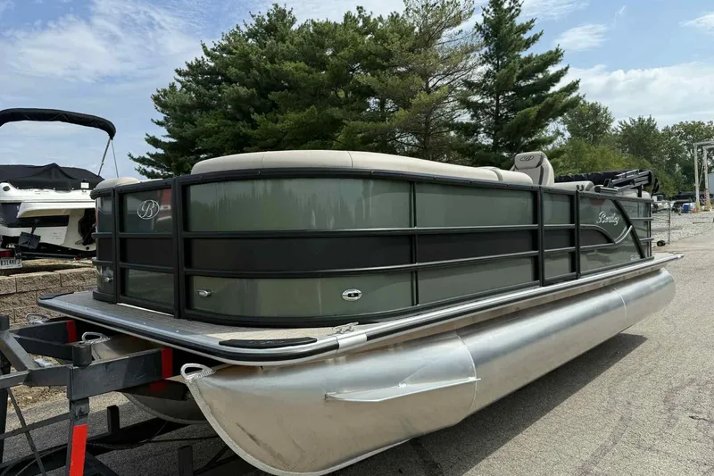 The Image of 2026 Bentley Pontoons Legacy 223 Navigator 3/4Tube on trailer, surrounded by trees. - 0