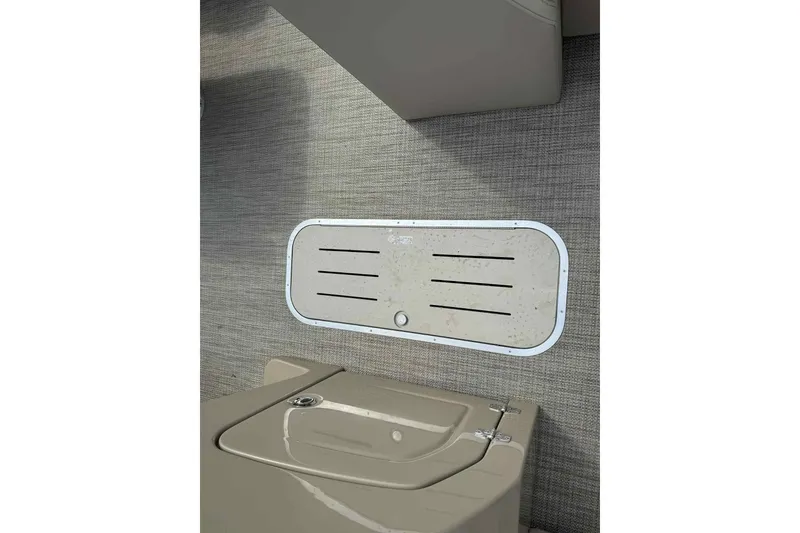 Slide: The Image of 2026 Bentley Pontoons Legacy 223 Navigator interior detail, featuring a sleek storage compartment. - 10