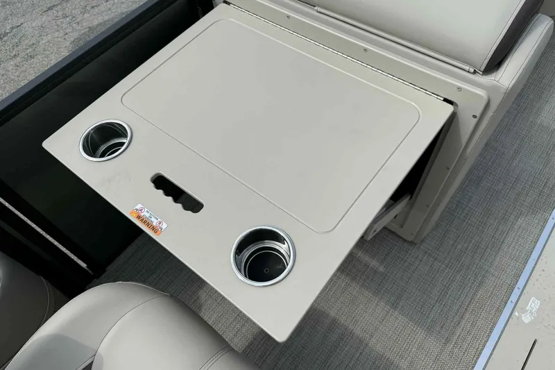 Slide: The Image of 2026 Bentley Pontoons Legacy 223 Navigator table with cup holders and storage. - 12
