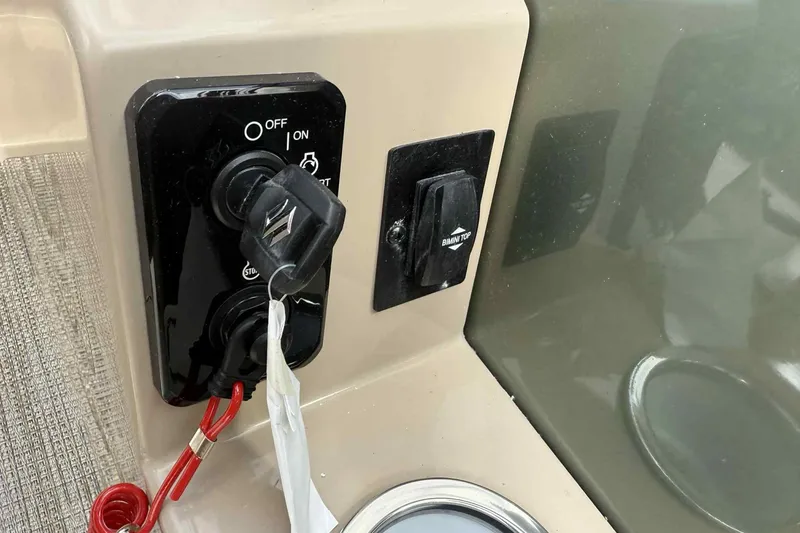 Slide: The Image of 2026 Bentley Pontoons Legacy 223 Navigator ignition and control panel close-up. - 19