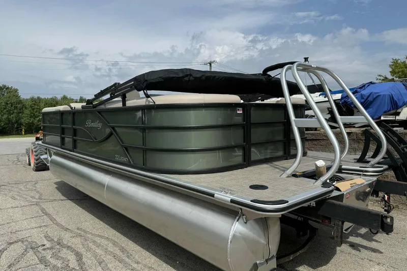 Slide: The Image of 2026 Bentley Pontoons Legacy 223 Navigator 3/4Tube on trailer, outdoor setting. - 5
