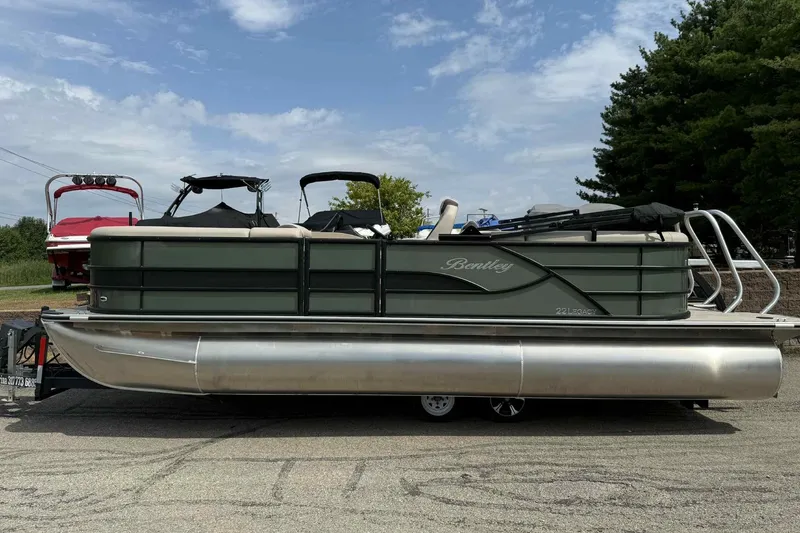 Slide: The Image of 2026 Bentley Pontoons Legacy 223 Navigator 3/4Tube on trailer, parked outdoors. - 6