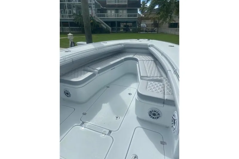 Slide: The Image of 2022 Yellowfin 32 boat interior with cushioned seating and speakers. - 3