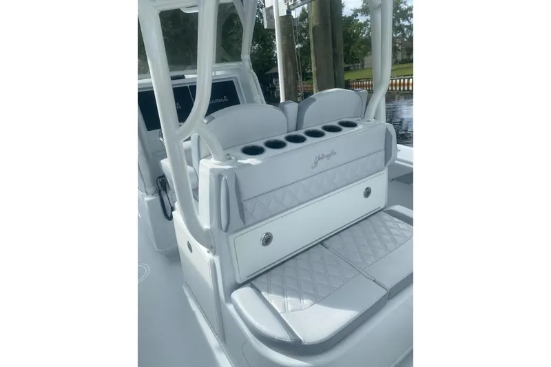 Slide: The Image of 2022 Yellowfin 32 boat interior with cushioned seating and cup holders. - 6