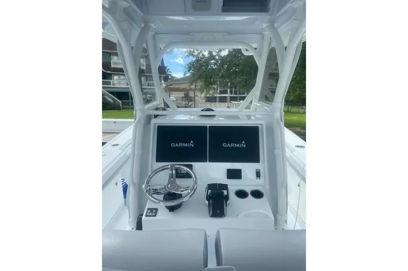 Slide: The Image of 2022 Yellowfin 32 boat dashboard with Garmin displays and steering wheel. - 8