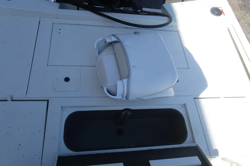Slide: The Image of 2025 Ranger RB210 boat deck with white seat and storage compartment. - 12