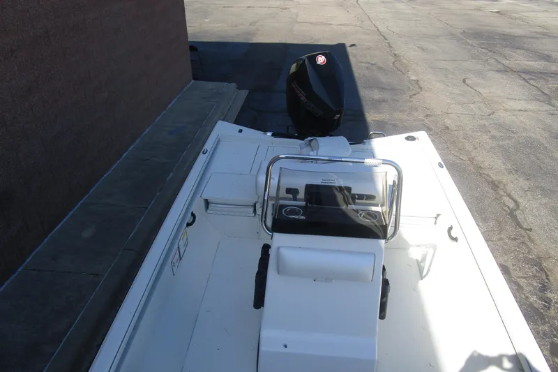 Slide: The Image of 2025 Ranger RB210 boat with outboard motor, parked on concrete surface. - 15