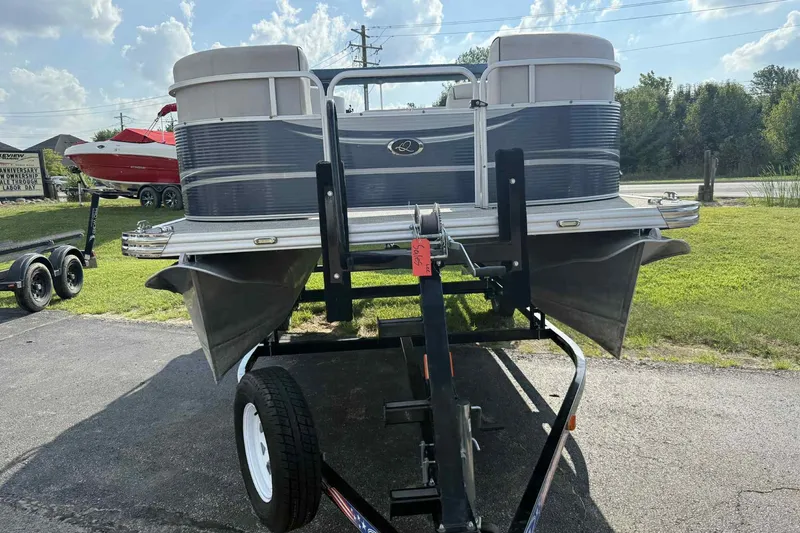 Slide: The Image of 2019 Qwest 816 Luxury Series pontoon boat on trailer, sunny day. - 1
