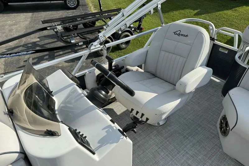 Slide: The Image of Captain's seat of 2019 Qwest 816 Luxury Series boat, featuring sleek design and controls. - 11