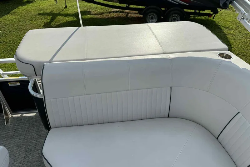 Slide: The Image of 2019 Qwest 816 Luxury Series boat seating with white upholstery and cup holder. - 16