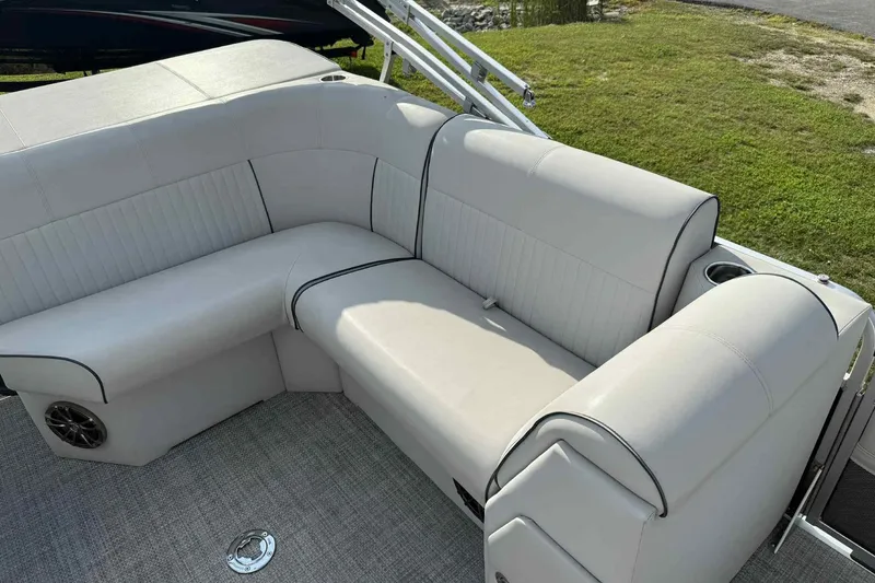 Slide: The Image of Luxurious seating on 2019 Qwest 816 Luxury Series boat, featuring plush upholstery and cup holders. - 17