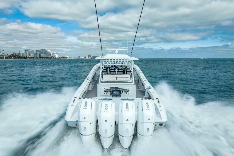 Slide: The Image of 2024 Yellowfin 54 Offshore boat cruising on open water, showcasing powerful engines and sleek design. - 10