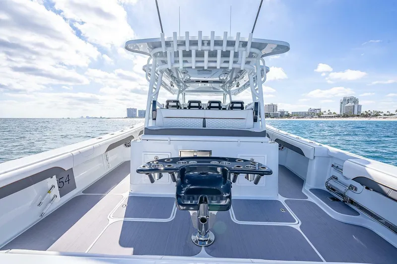 Slide: The Image of 2024 Yellowfin 54 Offshore boat interior with ocean view and city skyline. - 19