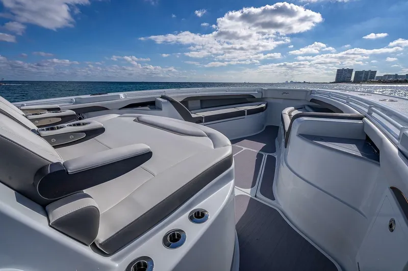 Slide: The Image of 2024 Yellowfin 54 Offshore boat interior with luxurious seating, ocean view, and clear sky. - 26