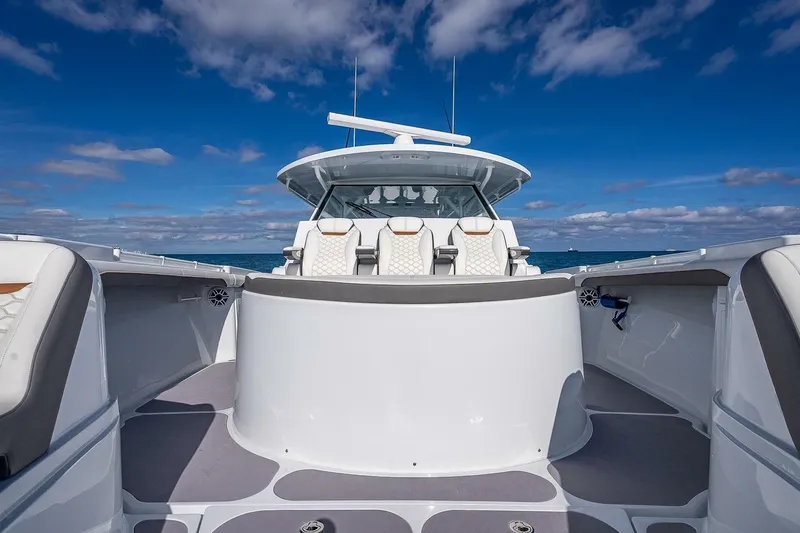 Slide: The Image of 2024 Yellowfin 54 Offshore boat with sleek design and luxurious seating on open water. - 27