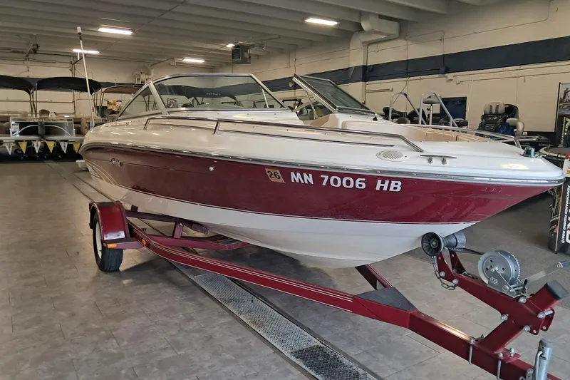 Slide: The Image of 1996 Sea Ray 190 Bow Rider boat on trailer in indoor showroom. - 2