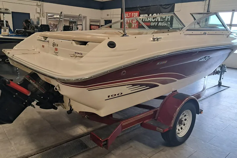 Slide: The Image of 1996 Sea Ray 190 Bow Rider boat on trailer in indoor showroom. - 4