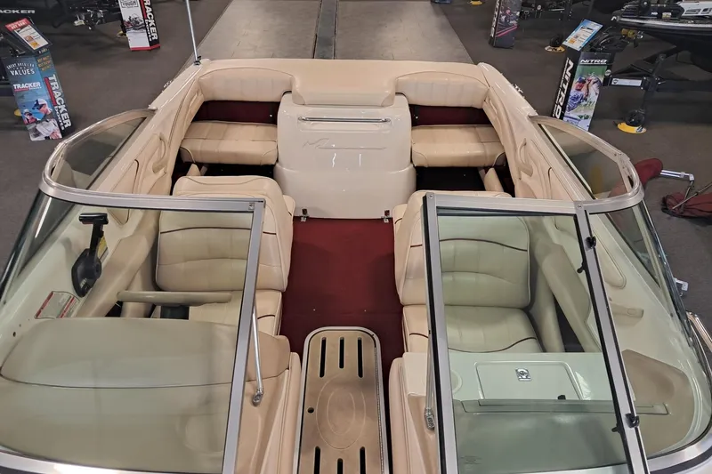 Slide: The Image of 1996 Sea Ray 190 Bow Rider interior with beige seating and red carpet. - 5