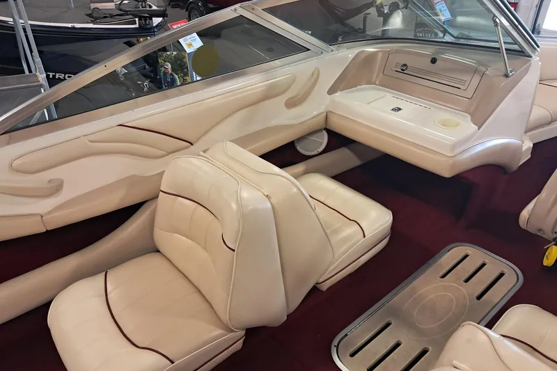 Slide: The Image of 1996 Sea Ray 190 Bow Rider interior with beige seating and red accents. - 7