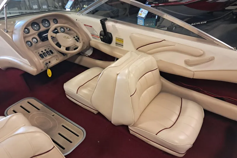 Slide: The Image of 1996 Sea Ray 190 Bow Rider interior with beige seats and dashboard controls. - 8