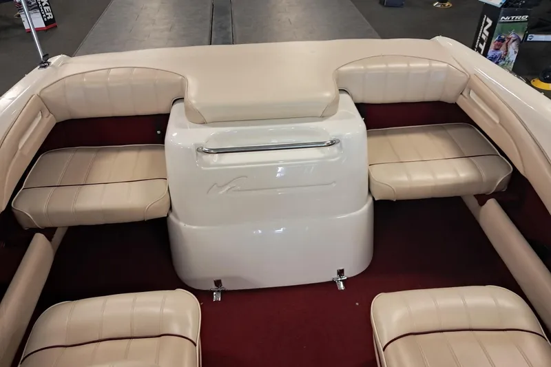 Slide: The Image of 1996 Sea Ray 190 Bow Rider interior with beige seating and red carpet. - 9