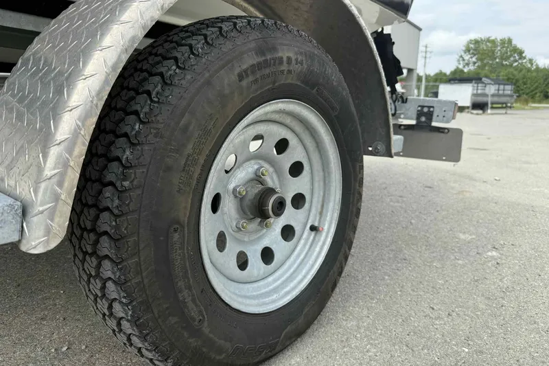 Slide: The Image of Trailer wheel of 2024 Galar Boats Typhoon with Seadoo GTI SE 155 on pavement. - 19