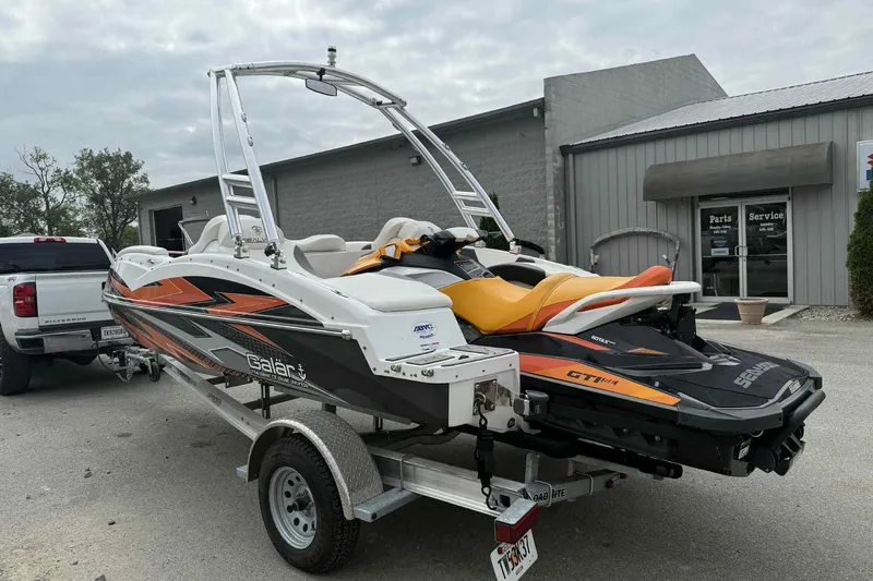 Slide: The Image of 2024 Galar Boats Typhoon with Seadoo GTI SE 155 on trailer, parked outside service center. - 4