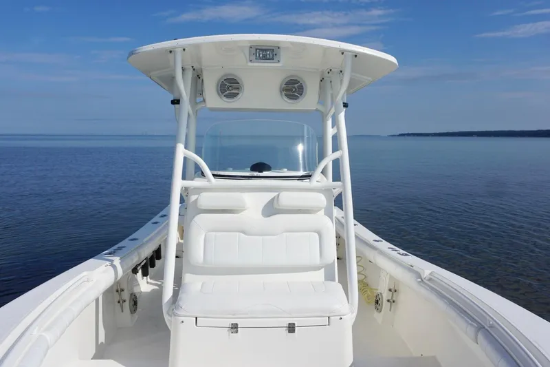 Slide: The Image of 2009 Regulator 24 FS boat on calm water under clear blue sky. - 10