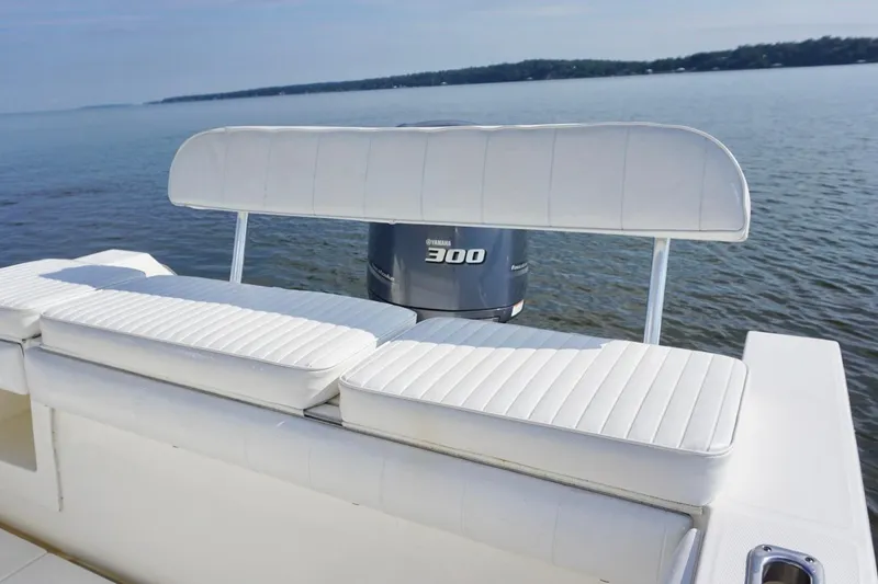 Slide: The Image of 2009 Regulator 24 FS boat with Yamaha 300 engine, white seating, on calm water. - 13