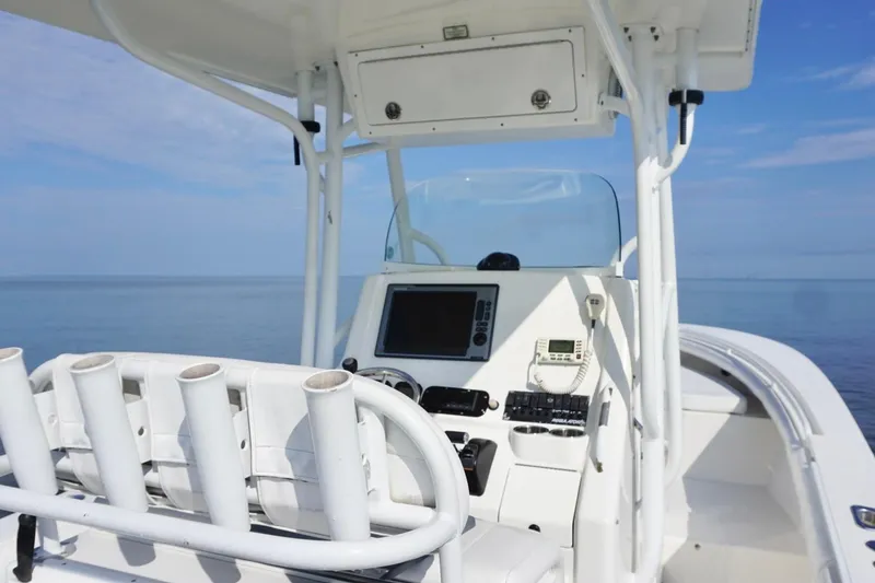 Slide: The Image of 2009 Regulator 24 FS boat console with ocean view, featuring navigation equipment. - 17