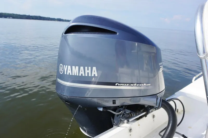 Slide: The Image of Yamaha four-stroke outboard motor on 2009 Regulator 24 FS boat, on calm water. - 19