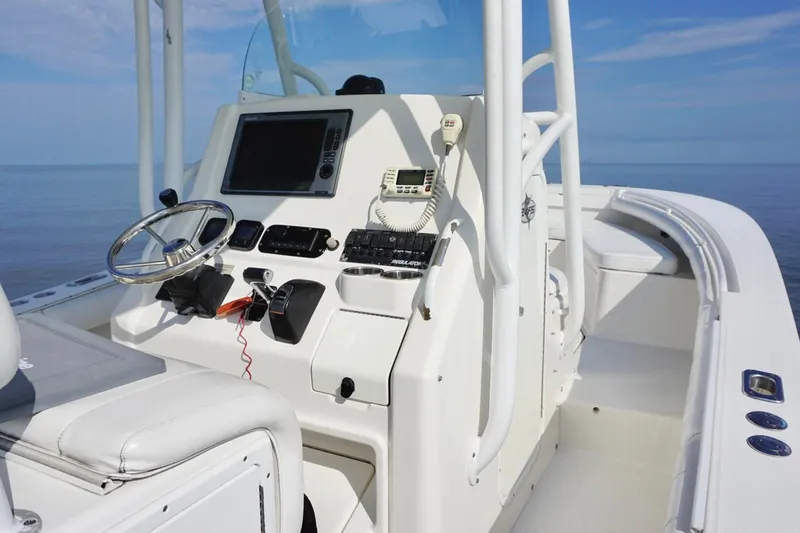 Slide: The Image of 2009 Regulator 24 FS boat cockpit with steering wheel and control panel. - 20