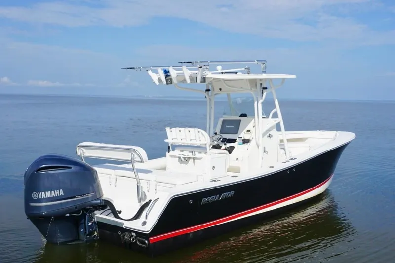 Slide: The Image of 2009 Regulator 24 FS boat with Yamaha outboard engine on calm water. - 4