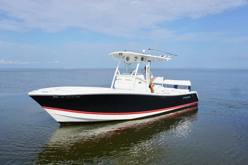Slide: The Image of 2009 Regulator 24 FS boat on calm water under a clear sky. - 6