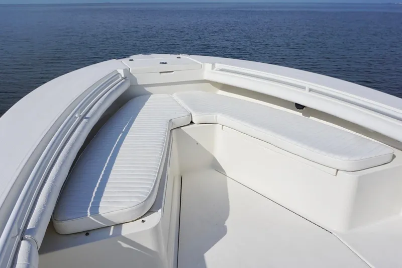 Slide: The Image of 2009 Regulator 24 FS boat with white cushioned seating on calm water. - 7