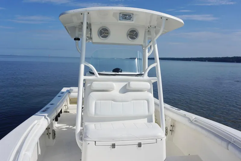 Slide: The Image of 2009 Regulator 24 FS boat on calm water, featuring a white console and seating. - 9