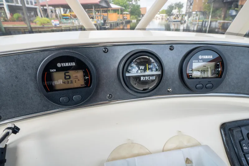 Slide: The Image of Dashboard of 2015 Scout 210 XSF boat with Yamaha gauges and Ritchie compass. - 18