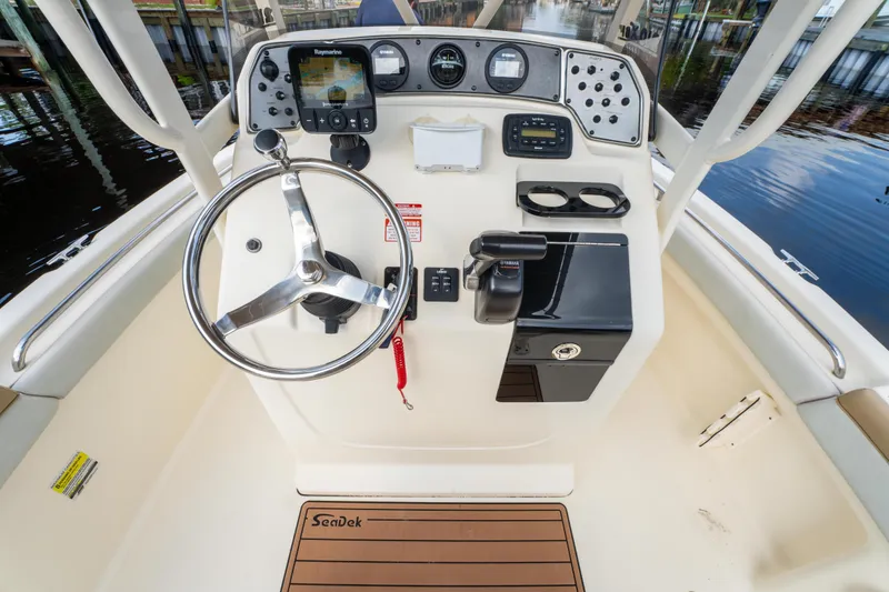 Slide: The Image of 2015 Scout 210 XSF boat dashboard with steering wheel and navigation controls. - 20