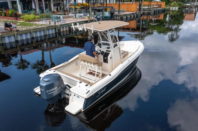 Slide: The Image of 2015 Scout 210 XSF boat with Yamaha engine on calm water near dock. - 4