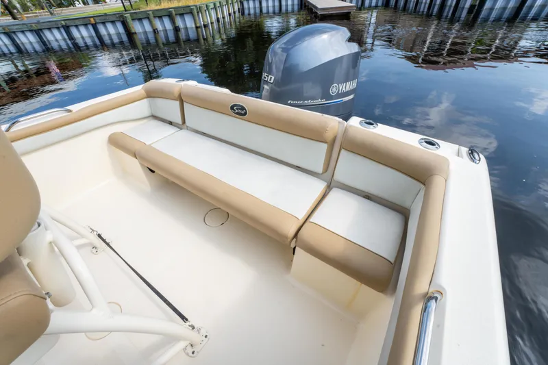 Slide: The Image of 2015 Scout 210 XSF boat interior with Yamaha engine, featuring beige seating. - 8