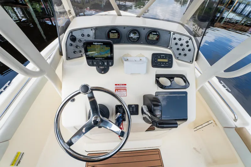 Slide: The Image of 2015 Scout 210 XSF boat dashboard with steering wheel and navigation controls. - 9