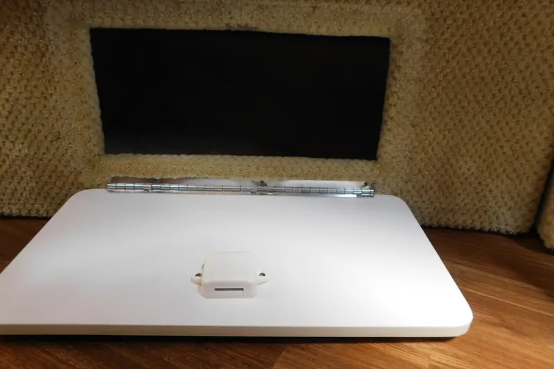 Slide: The Image of 2005 Sea Ray 320 Sundancer interior detail with hinged panel and carpeted walls. - 100