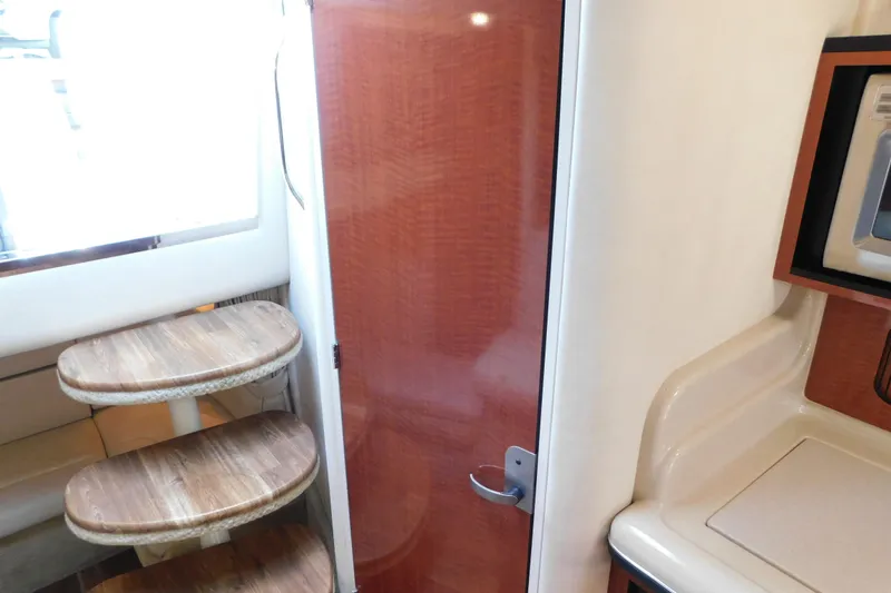 Slide: The Image of Interior of 2005 Sea Ray 320 Sundancer with wooden steps and cabinetry. - 102