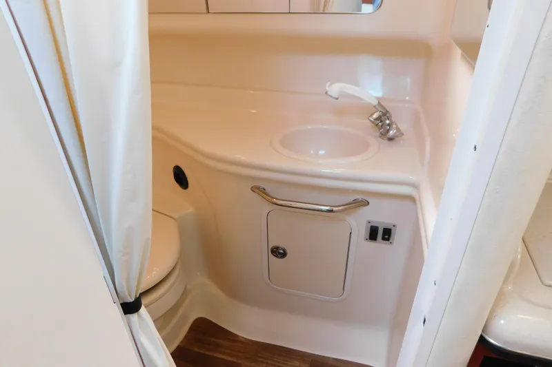 Slide: The Image of 2005 Sea Ray 320 Sundancer bathroom with sink, faucet, and storage cabinet. - 103