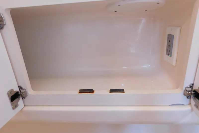 Slide: The Image of Open storage compartment with outlet in 2005 Sea Ray 320 Sundancer boat. - 110