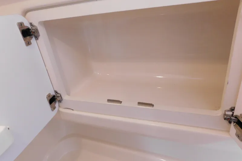 Slide: The Image of Open storage compartment on a 2005 Sea Ray 320 Sundancer boat. - 111