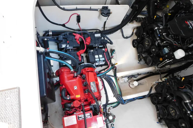 Slide: The Image of Engine compartment of a 2005 Sea Ray 320 Sundancer with visible batteries and wiring. - 116
