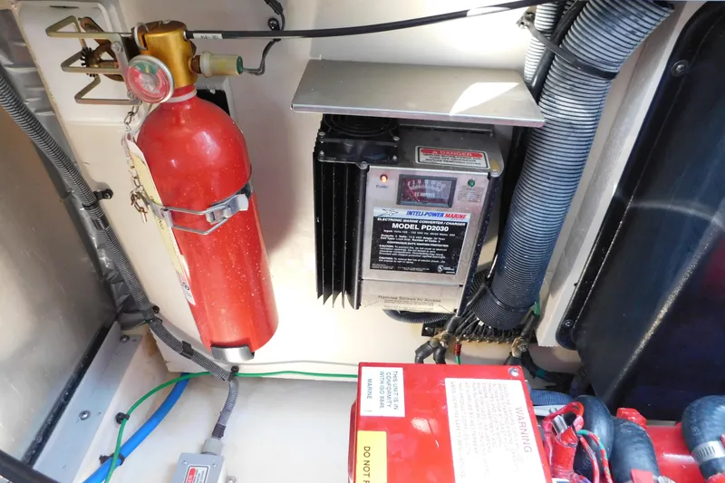 Slide: The Image of Engine compartment of 2005 Sea Ray 320 Sundancer with fire extinguisher and power converter. - 119