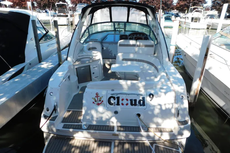 Slide: The Image of 2005 Sea Ray 320 Sundancer docked, featuring spacious seating and "Cloud 9" nameplate. - 12
