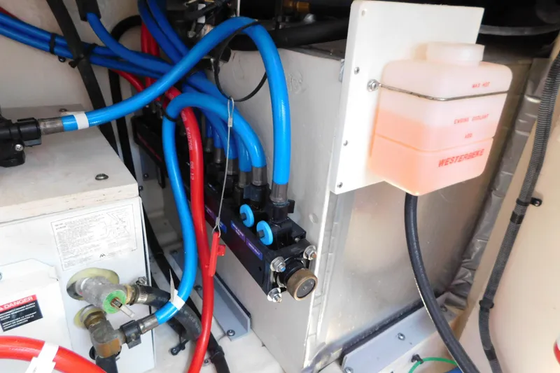 Slide: The Image of Engine compartment of 2005 Sea Ray 320 Sundancer with coolant reservoir and wiring. - 120